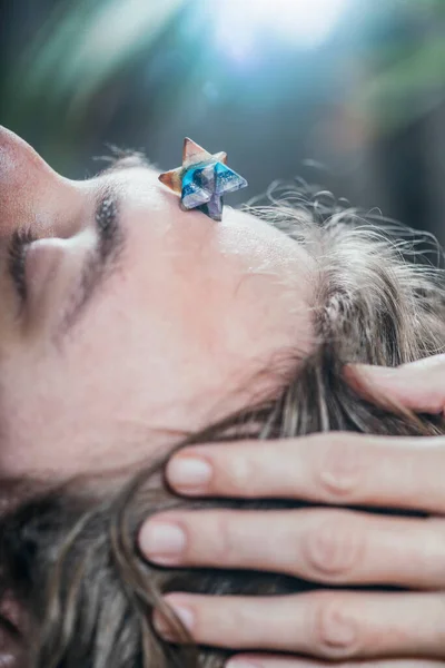 Young Man Lying Massage Table Having Merkaba Crystal Healing Session — Zdjęcie stockowe