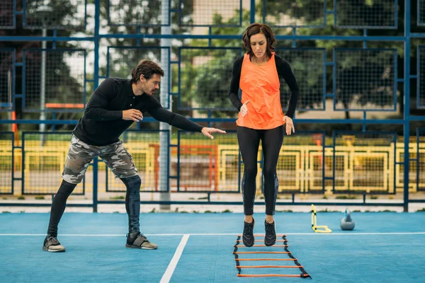 Young Woman Exercising Personal Fitness Coach Using Agility Ladder Agility — стоковое фото