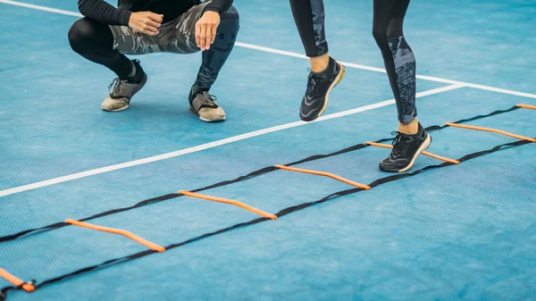 Young Woman Exercising Personal Fitness Coach Using Agility Ladder Agility — Foto de Stock