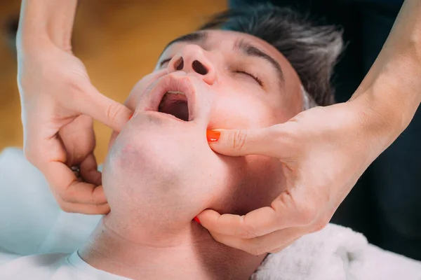 Jaw Realignment Massage Therapist Massaging Mans Jaw — стоковое фото
