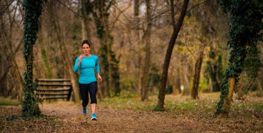 Female Athlete Jogging in Park. Autumn, Nature