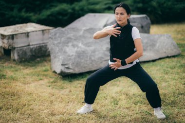 Woman practicing Qi Gong in the park