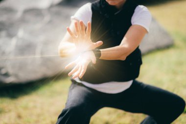 Qi Gong practice. Mature woman exercising Qi Gong in a park.