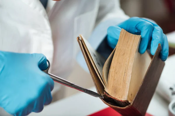 Old book repair in restoration laboratory