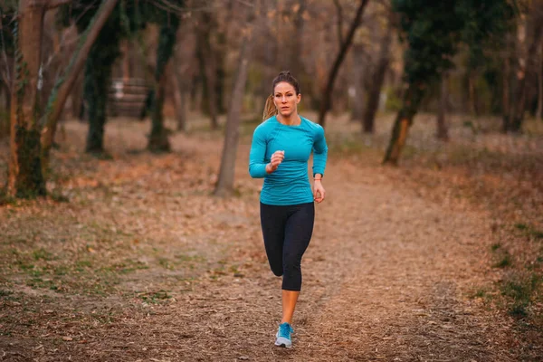 Female Athlete Jogging Park Autumn Nature — Stock fotografie