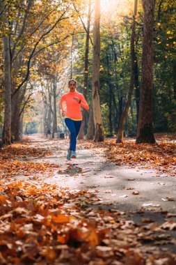 Woman Jogging in the Park in Fall