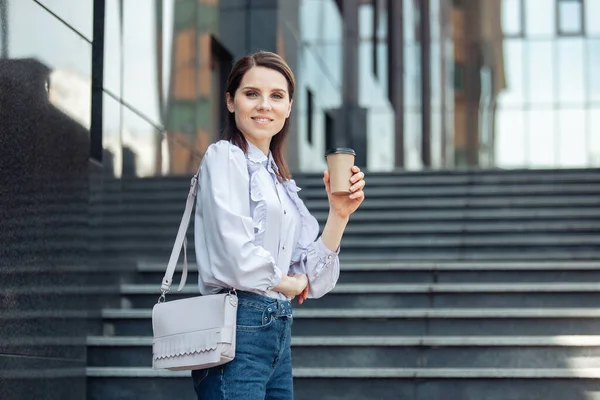 Uśmiechnięta Bizneswoman Trzymająca Filiżankę Kawy Podróży — Zdjęcie stockowe