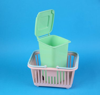 Mavi arka planda alışveriş sepeti ve çöp kutusu