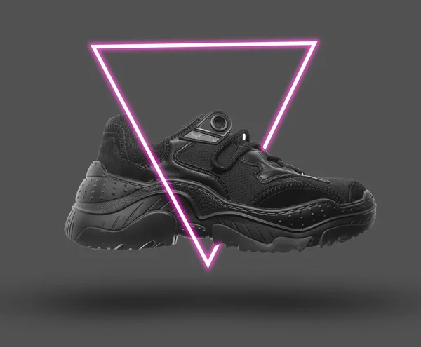 Black sneaker. 80\'s synth wave and retrowave glowing triangle futuristic aesthetics. Old fashioned abstraction concept