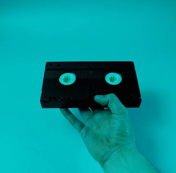 Male Hand Holds Retro Video Cassette Blue Neon Light — Stock Photo, Image