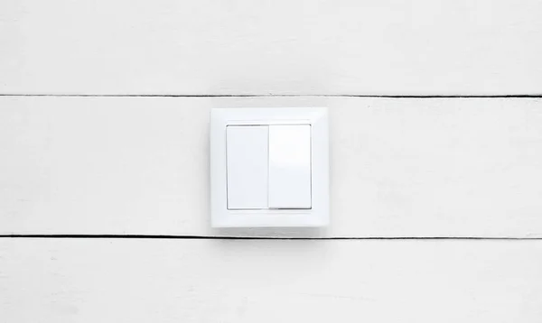 Switch on white wooden wall, minimalism