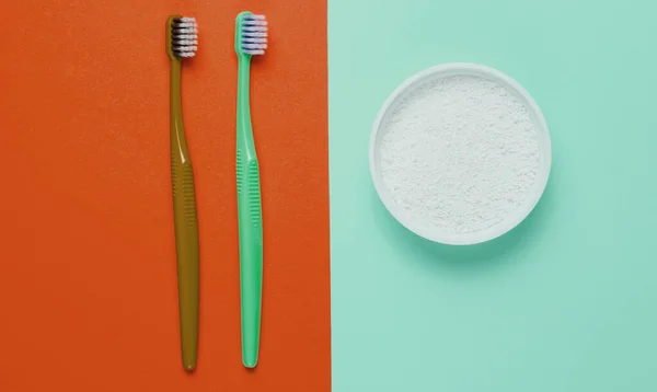 Two Toothbrushes Tooth Powder Orange Blue Background Minimalism Oral Hygiene — Stock Photo, Image