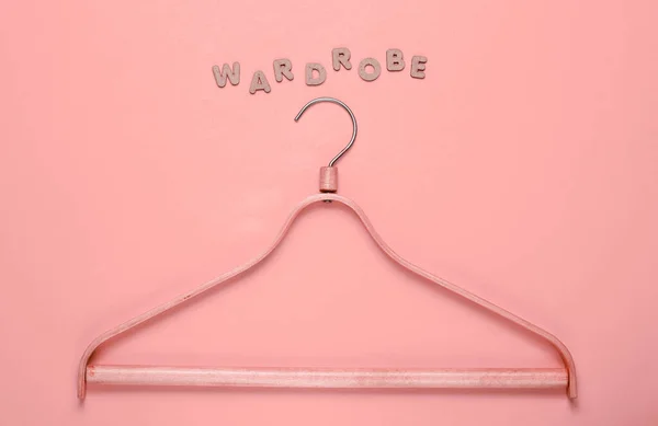 Wooden Hanger Pink Background Word Wardrobe Top View — Stok fotoğraf