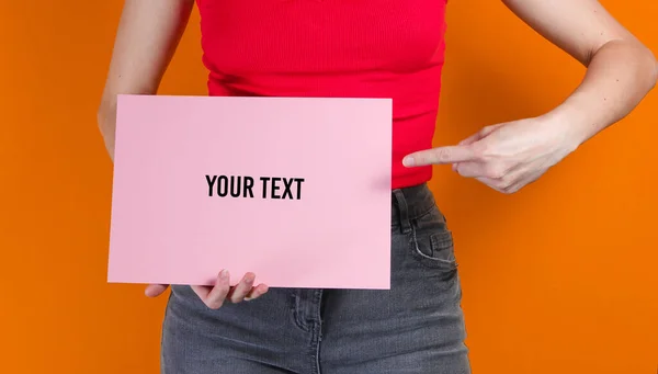 Woman Holding Pink Empty Sheet Paper Copy Space Orange Background — Foto Stock