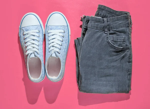 Minimalism Fashion Concept Fashionable Sneakers Jeans Pink Background Top View — Zdjęcie stockowe