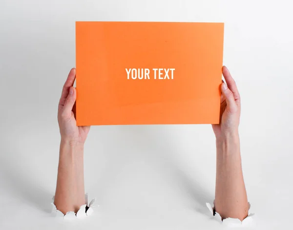 Female Hands Holding Orange Sheet Paper Copy Space Torn Holes — Stock Fotó