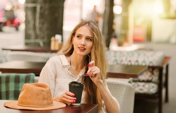 유쾌하게 금발의 여자가 거리의 카페에 커피를 마시고 — 스톡 사진