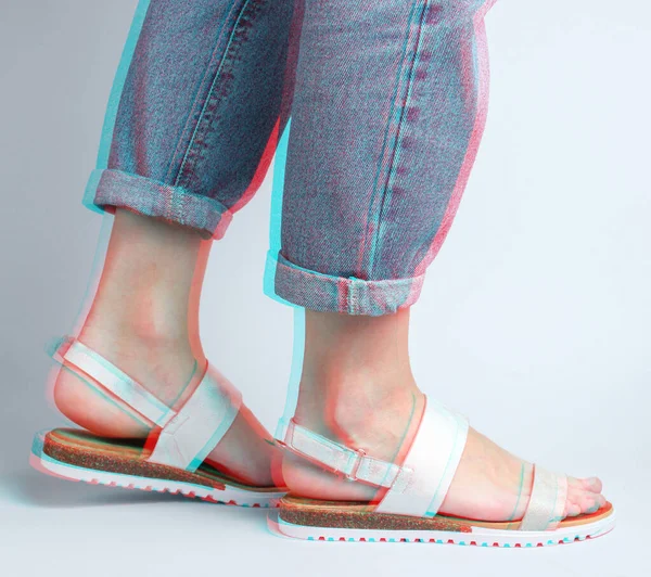 Fragment Female Legs Blue Jeans Trendy Leather Sandals White Background — стоковое фото