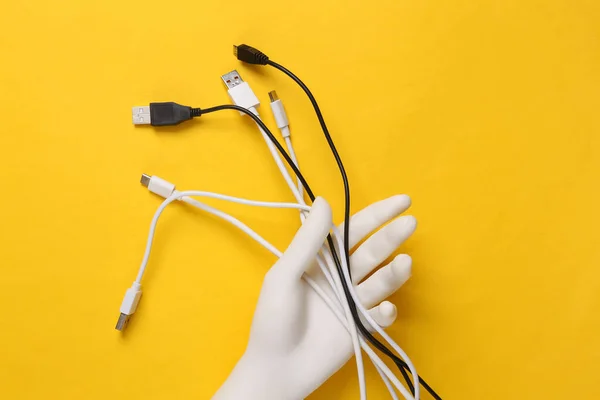 White Plastic Hand Holding Different Usb Cables Yellow Background Top — Stock Photo, Image