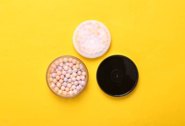 Sarı arka planda barut topları. Kozmetik. Üst görünüm