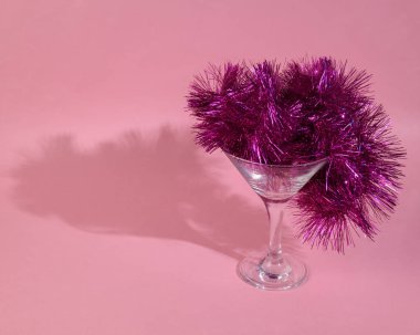 Pembe arka planda Noel çelengi olan cam. Asgari Noel partisi konsepti 