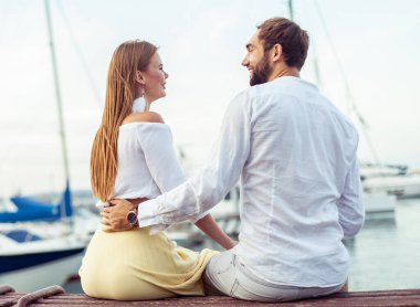Beautiful couple in love spending time together in the yacht club