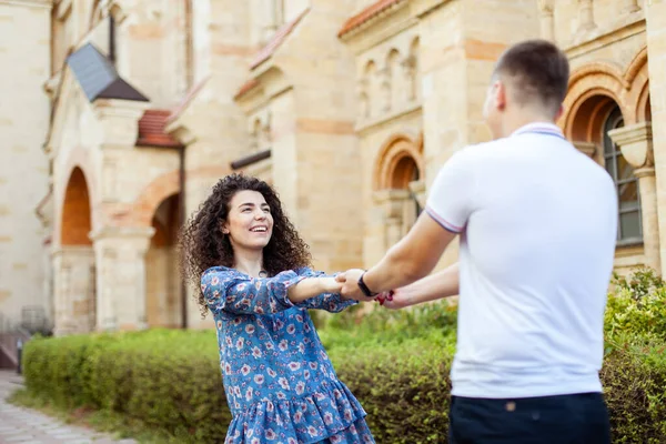 Young Couple Whirling Hold Hands Having Fun Outdoors — Stok fotoğraf