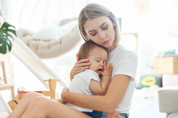 Caring Mom Lulls Her Little Daughter Her Arms Playroom — Stock Photo, Image