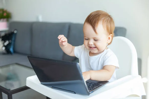 Little Funny Baby Uses Laptop While Sitting Children Table Home — Stock fotografie