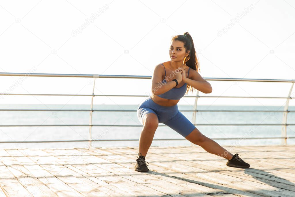 Active lifestyle. Fitness woman exercising muscles on the beach