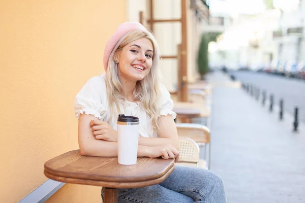 Young Pensive Woman Beret Smiling Looking Camera While Sitting Table — Stockfoto