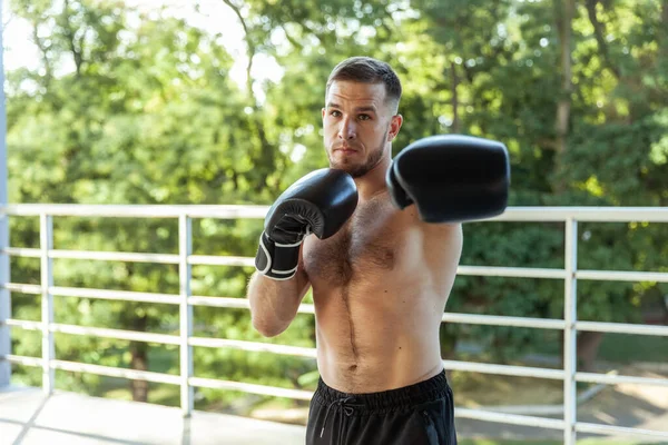 Muscular Man Training Punches Boxing Gloves Outdoors — Zdjęcie stockowe
