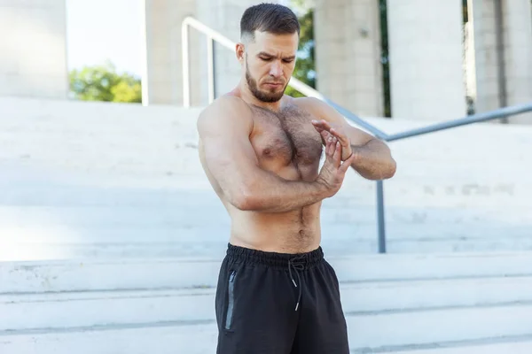 Young Male Athlete Naked Torso Kneads Muscles Doing Stretching Exercise — Photo