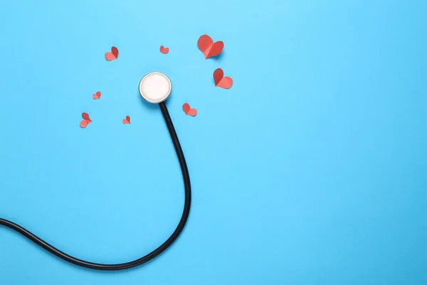 Stethoscope with a hearts on blue background. Love concept. Top view