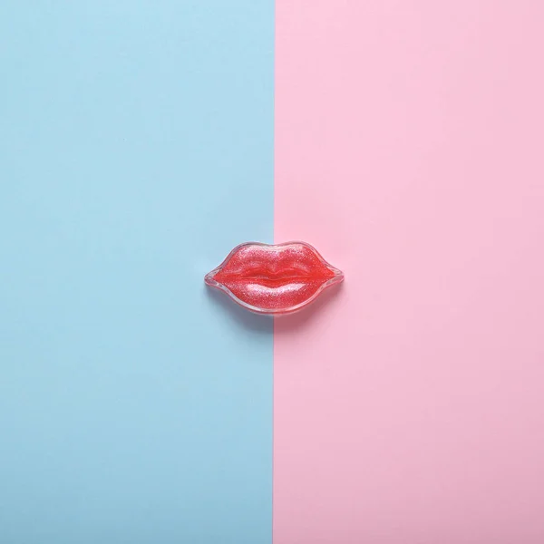 Red lips on a pink blue background. Beauty minimal concept