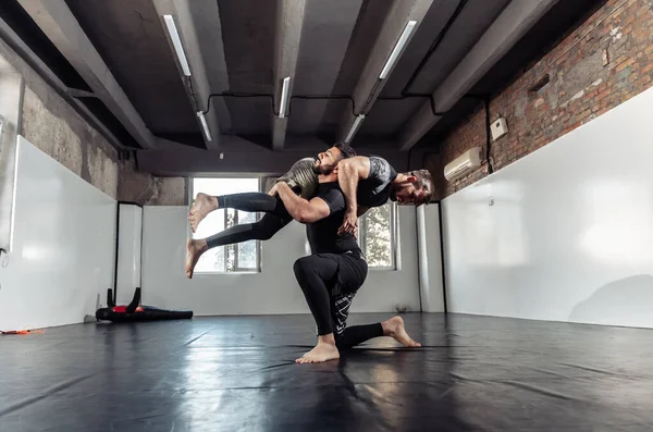 Sparring training of two athletic mma fighters in the gym. Martial arts, Wrestling