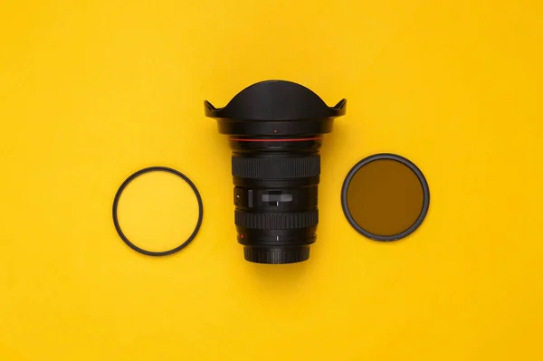 Professional Lens Filters Yellow Background Top View — Stock Photo, Image