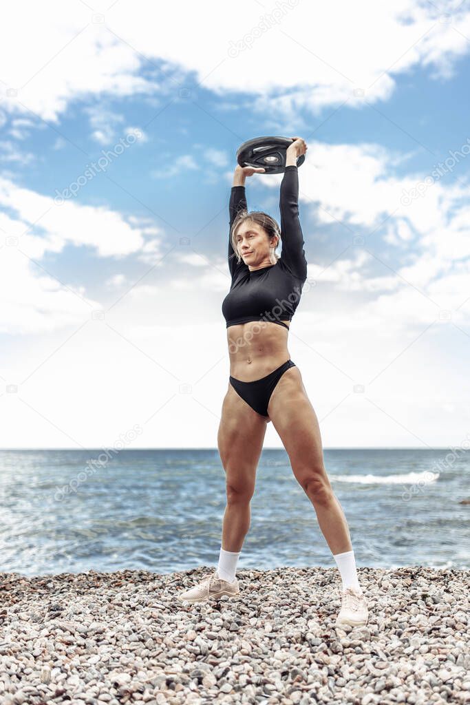 Strong athletic woman exercising with barbell