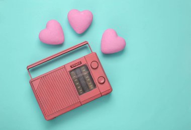Mavi arka planda kalpleri olan eski radyo alıcısı. Romantik melodi. Üst görünüm