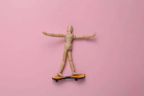 Wooden Puppet Skateboard Pink Background Top View — Fotografia de Stock