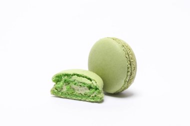 Green macaroon isolated on white background. French sweet delicacy, popular dessert