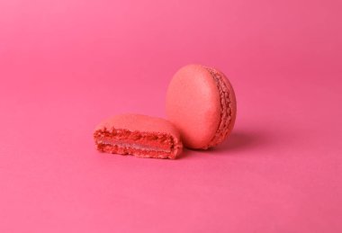 Pink macaroon on pink background. French sweet delicacy. Color trend