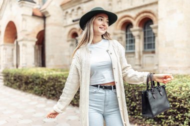 Cute smiling fashion woman having fun in the city