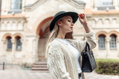 Young fashion woman spends time in the city. Lifestyle