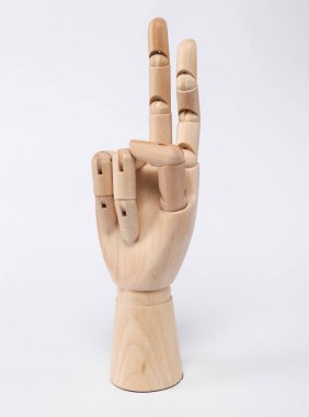 Wooden hand, two fingers up, peace symbol, isolated on white background
