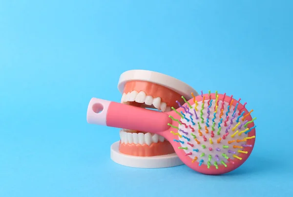 Beauty minimal still life. Jaw with hairbrush on a blue background