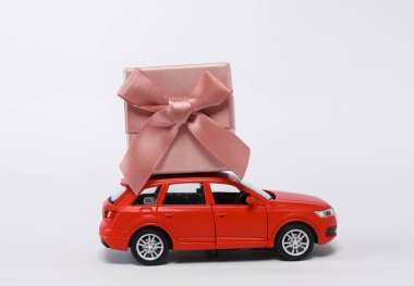 Small car model with gift box isolated on white background