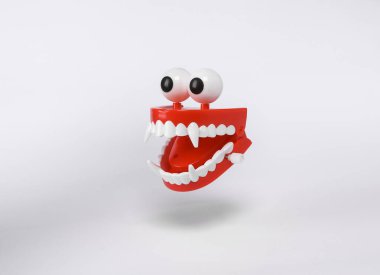 Floating Clockwork jaw with vampire fangs on white background with shadow