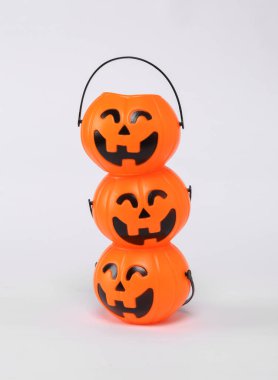 Stack of plastic jack'o lantern candy buckets for halloween. Trick or Treat