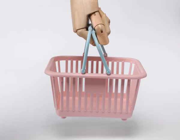 Wooden Hand Holding Plastic Supermarket Basket Isolated White Background — 스톡 사진